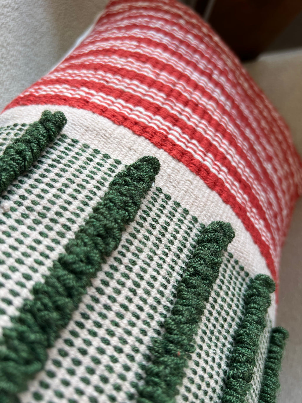 Handwoven green, red and off-white cushion