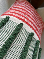 Handwoven green, red and off-white cushion